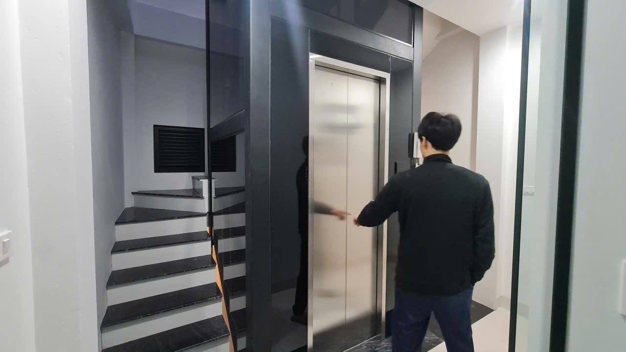 Khách hàng nghiệm thu, bấm gọi thang trước cửa tầng inox thang máy nhà phố Hà Đông