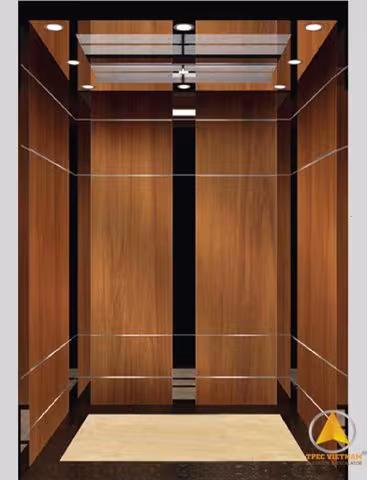 Mẫu cabin thang máy ốp vân gỗ nâu ấm, viền chỉ inox, sàn đá màu kem sáng